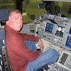 Jeff Hoff seating in the commanders seat of the shuttle orbiter.