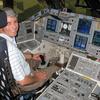 Frank Wadsworth seating in the commanders seat of the shuttle orbiter.