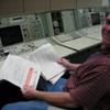 Apollo Era Mission Control Room - Jeff Hoff looking over some historic papers inside the console drawers